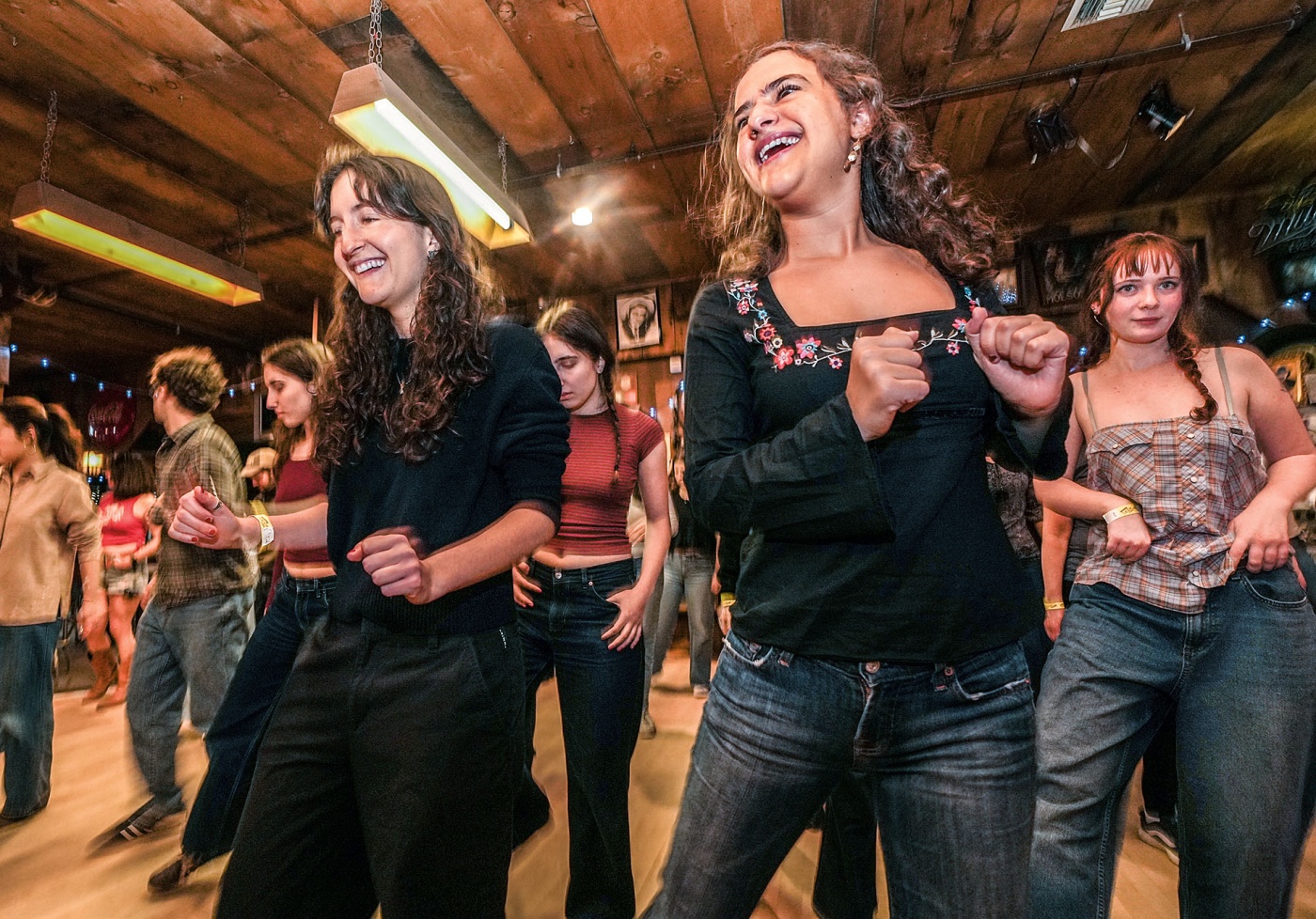 Image of students line dancing in a barn