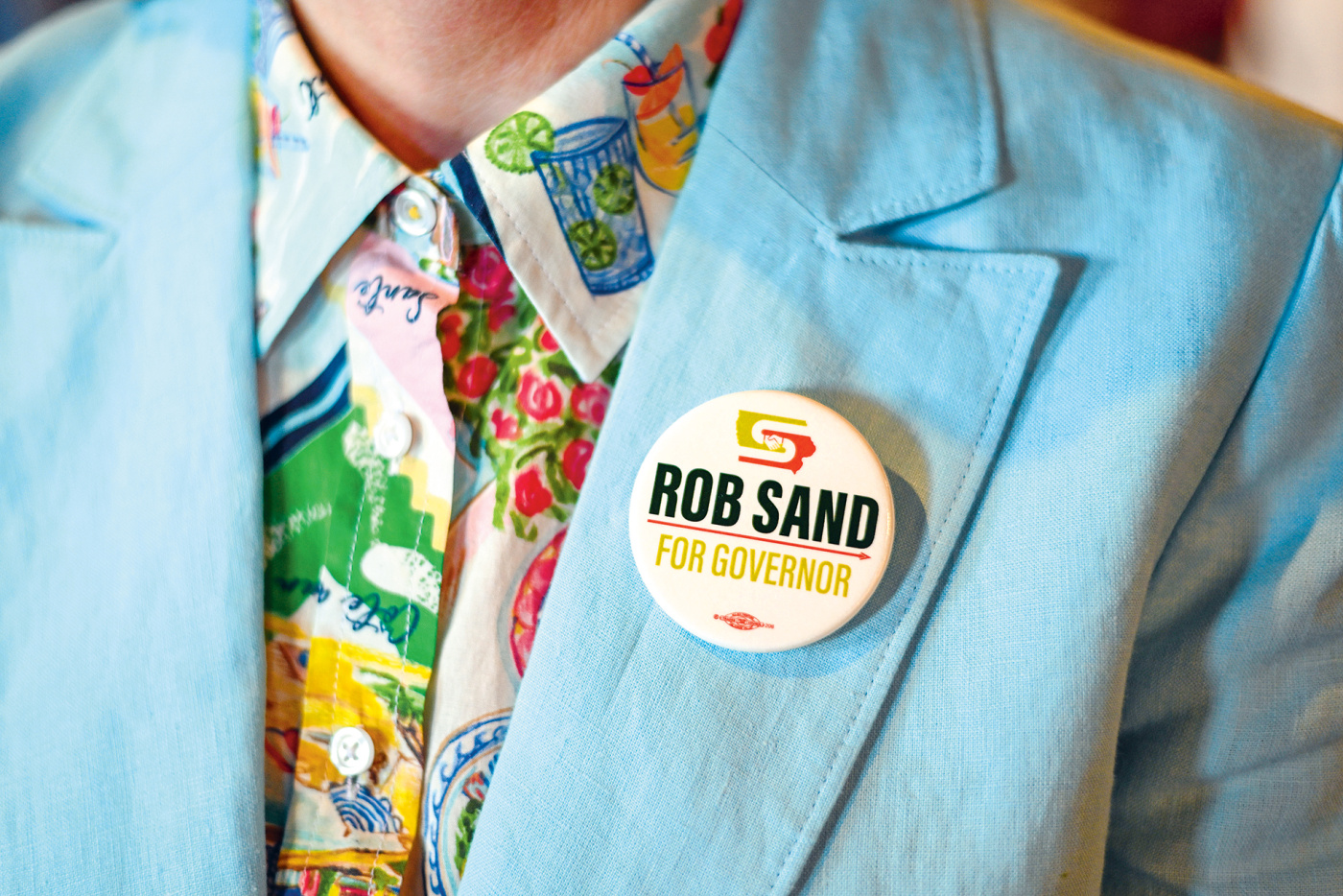Close up of the Sand button on a supporter's lapel