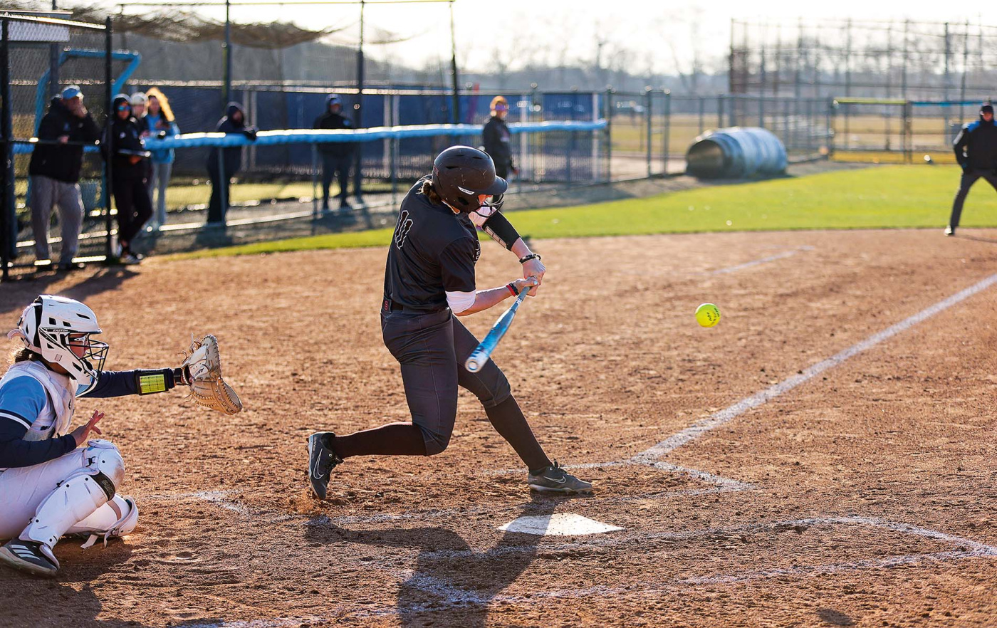 Maggie Foxx hitting a softball