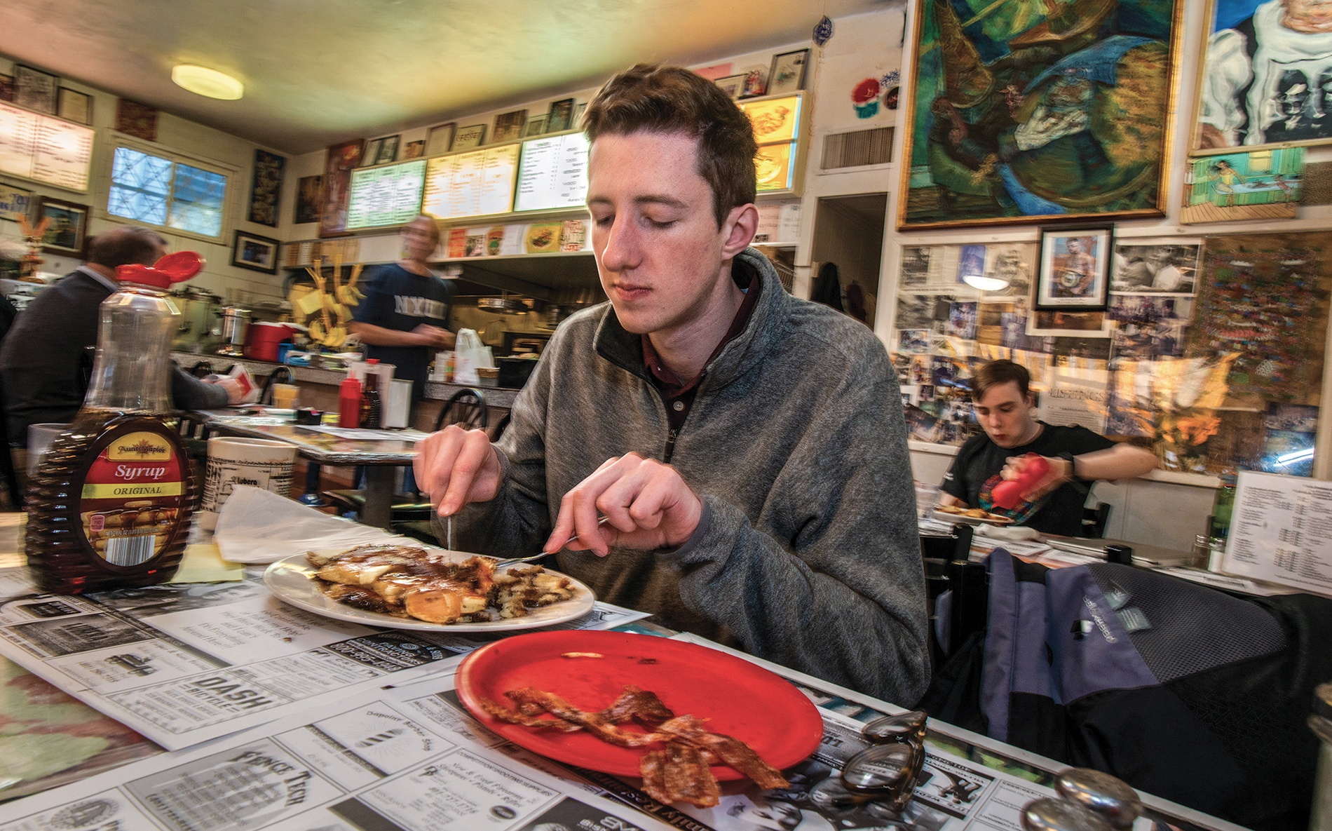 Student Peter Deegan eats pancakes at Louie's