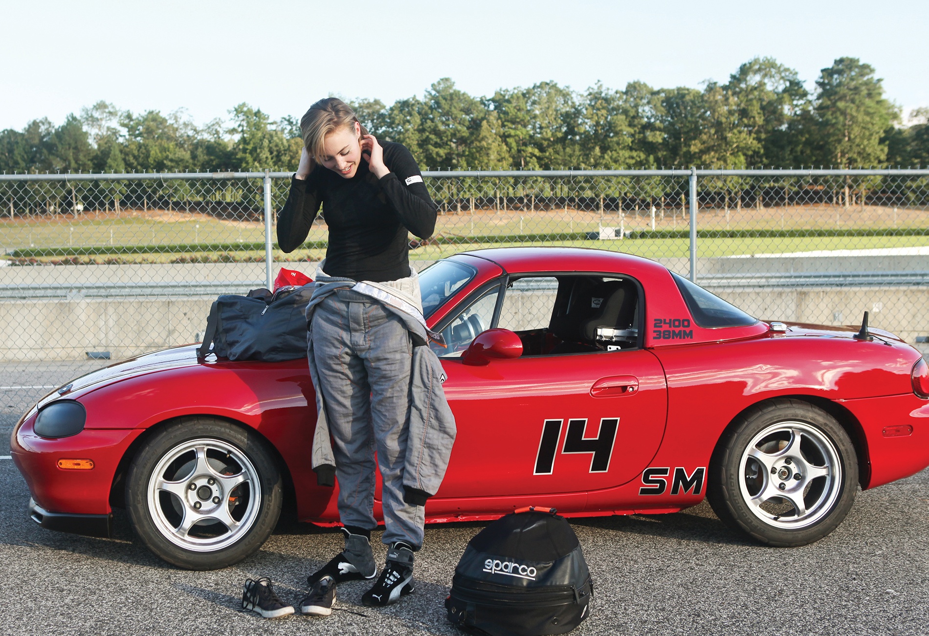 Sydney McKee donning her racing suit