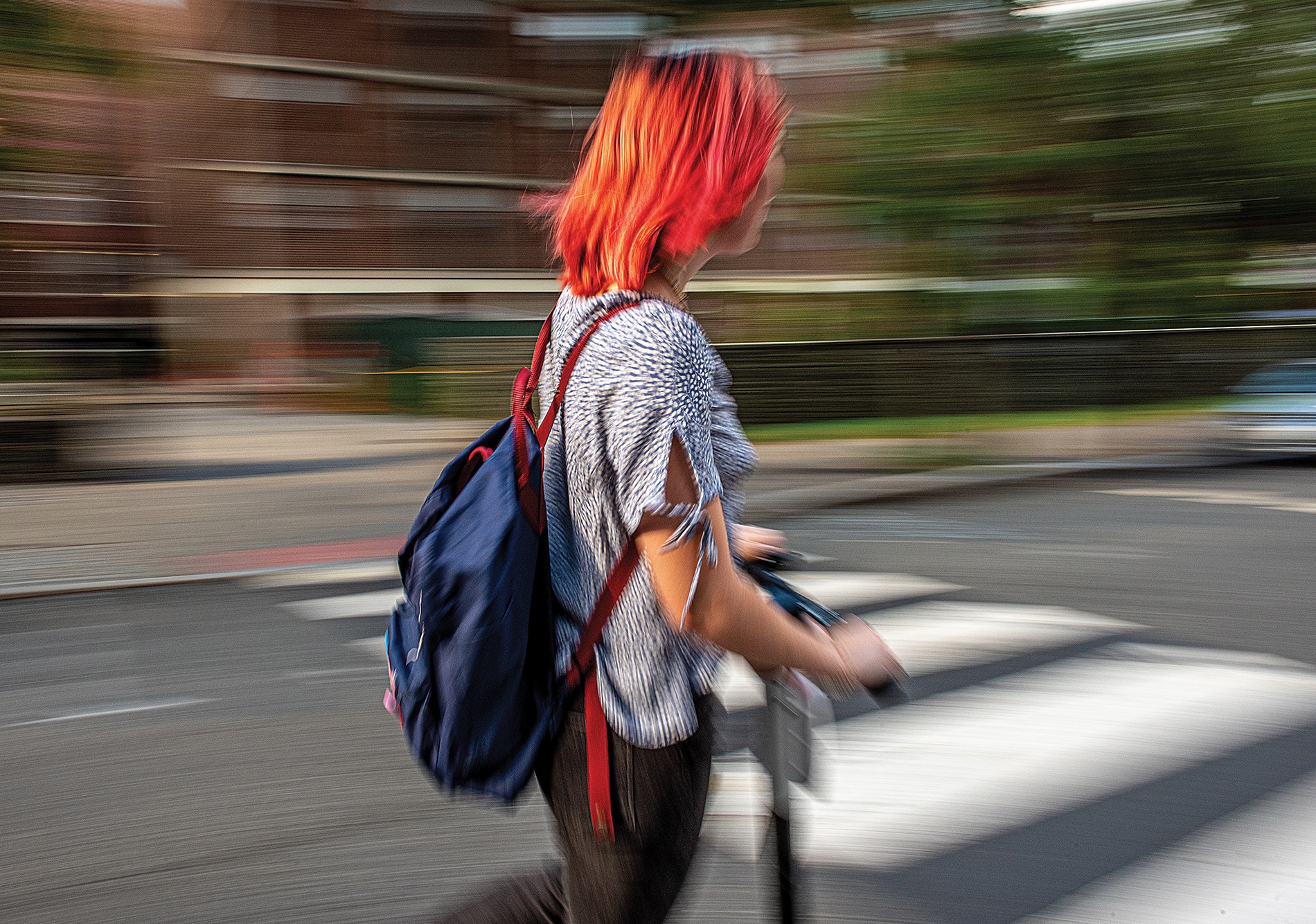 Motion-blurred photo of a student on a scooter