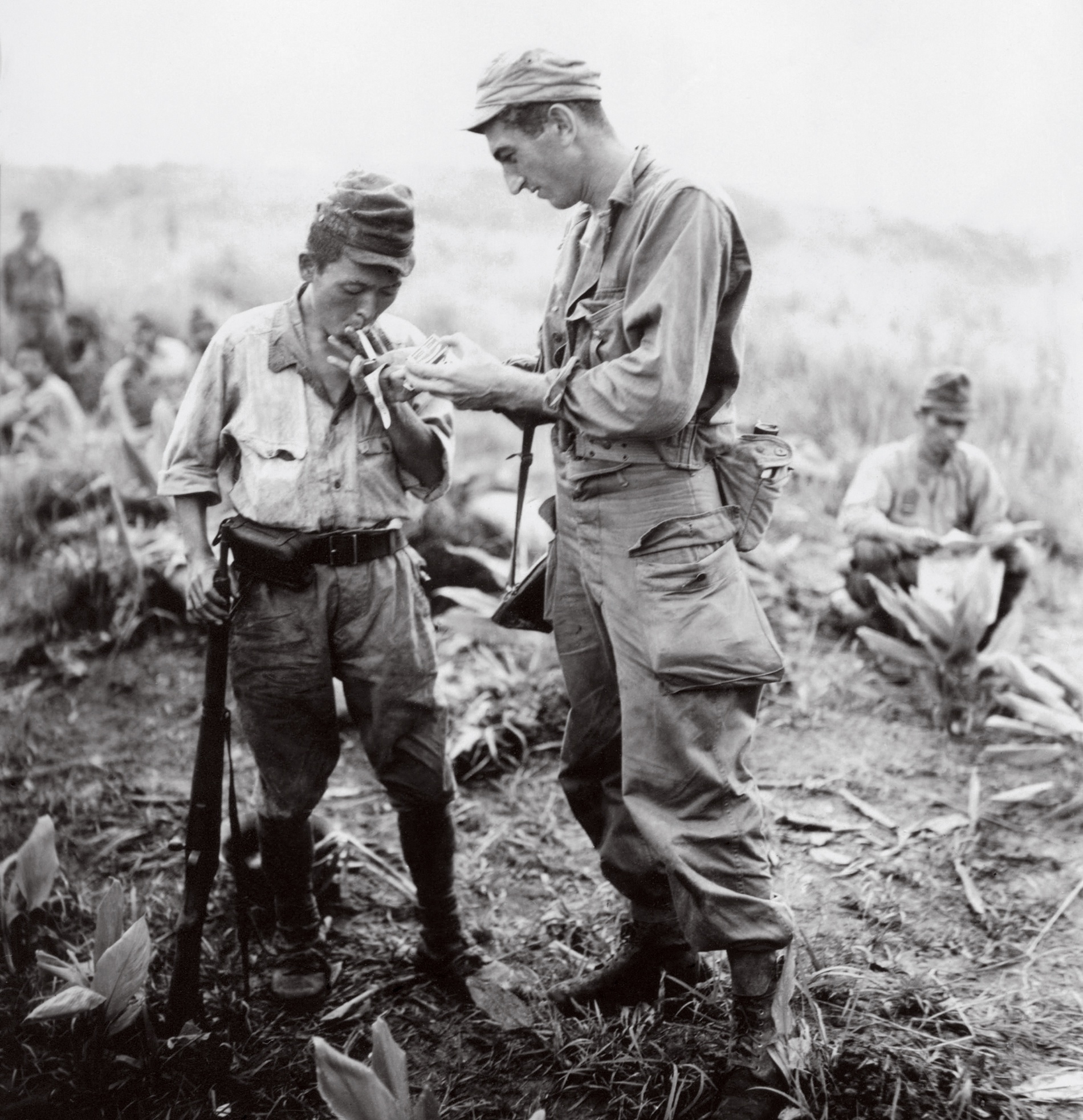 An American soldier lights the cigarette of a Japanese prisoner