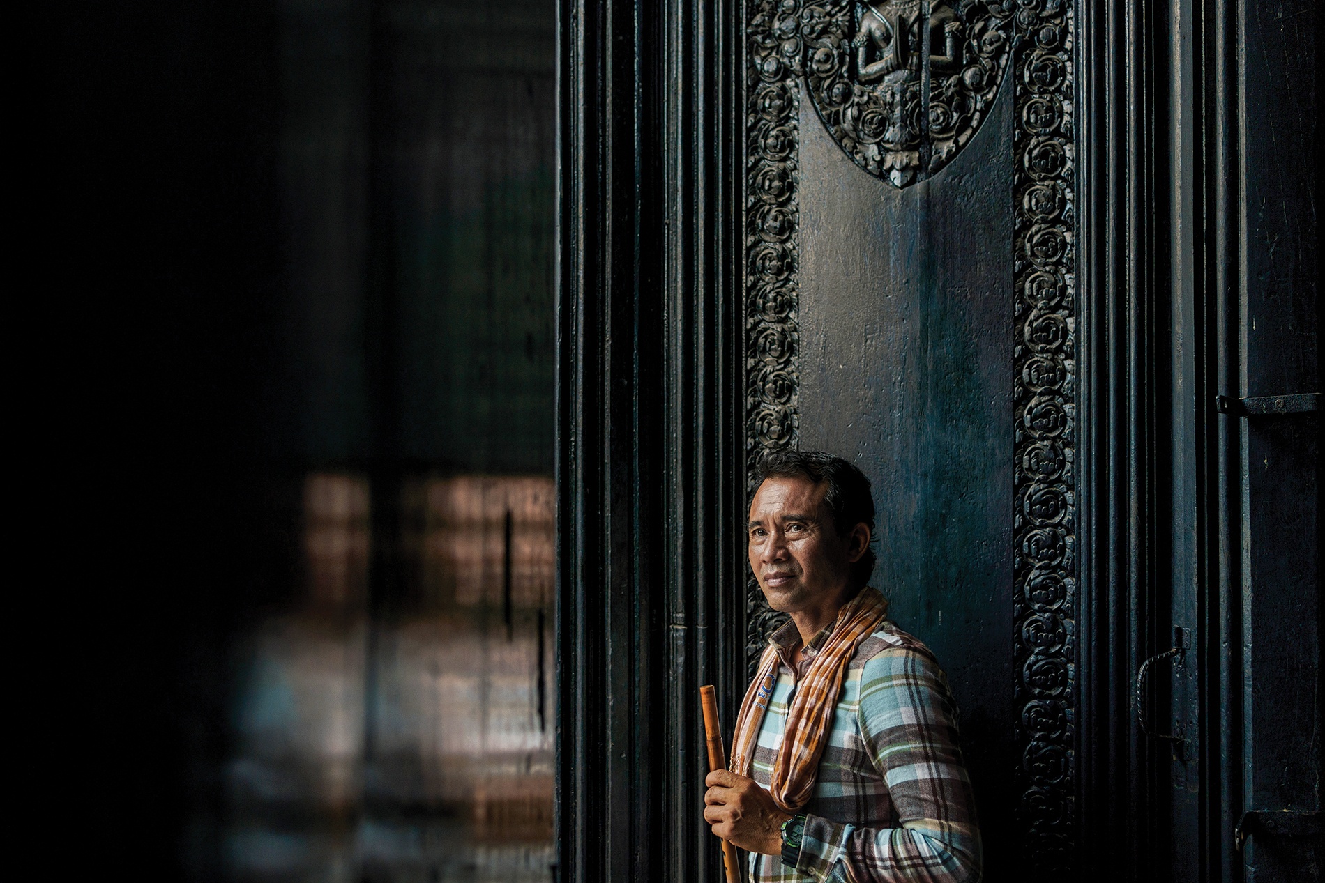 portrait of Arn Chorn Pond holding his flute