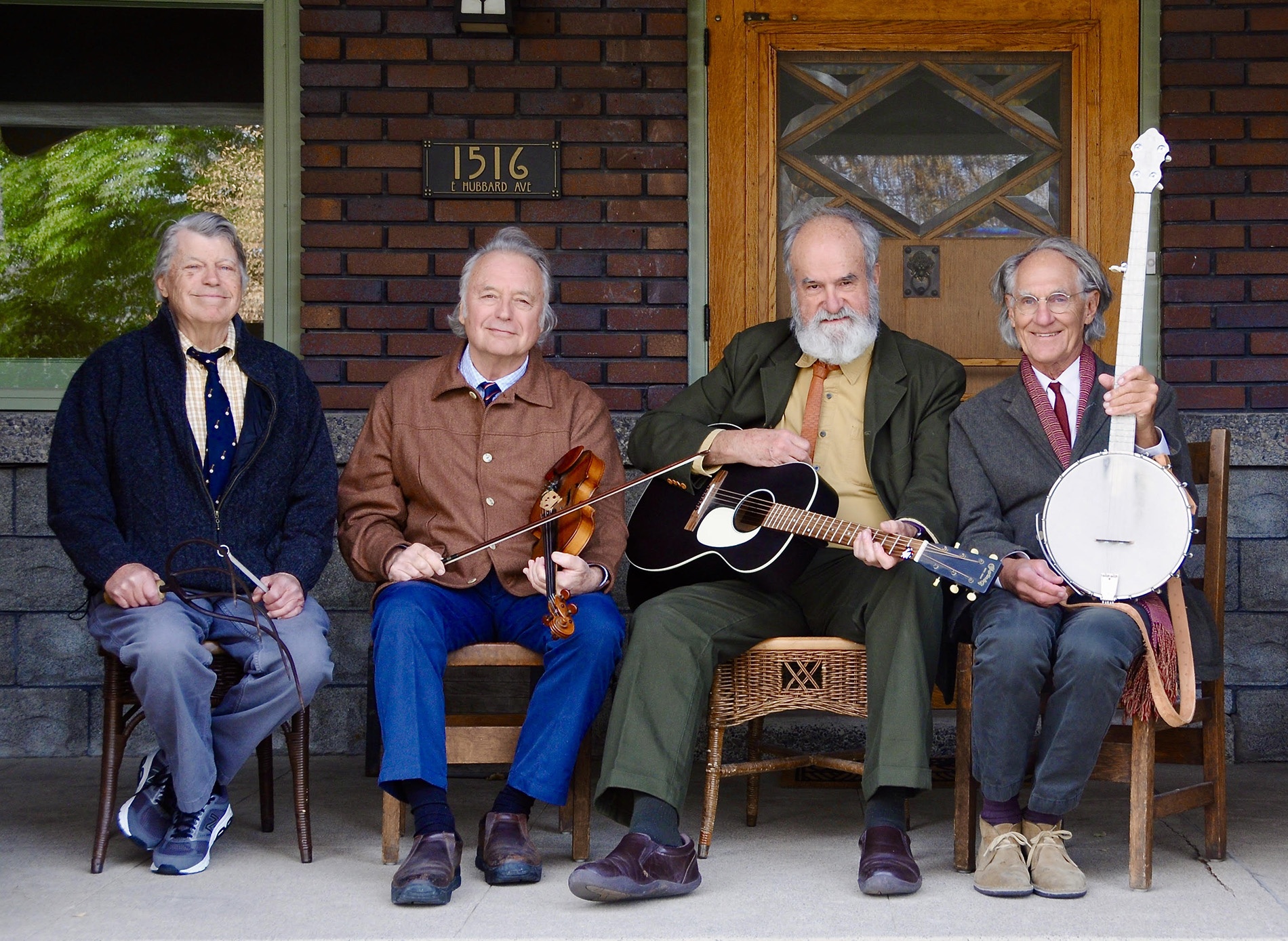 Image of the "Rhode Island Mudflaps" bandmates on a porch with instruments