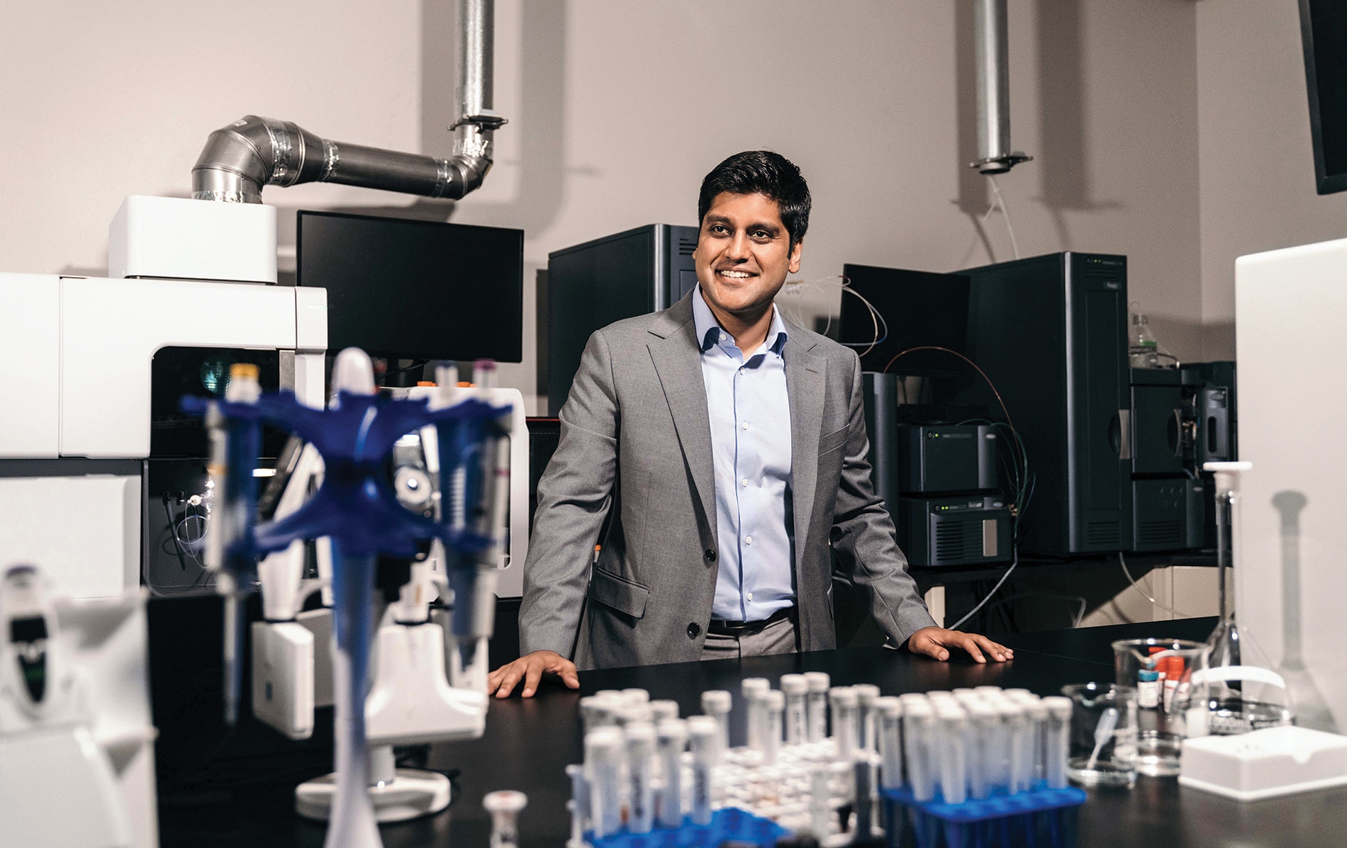 Image of Gaurab Ghakrabarti at Solugen surrounded by scientific equipment and test tubes.