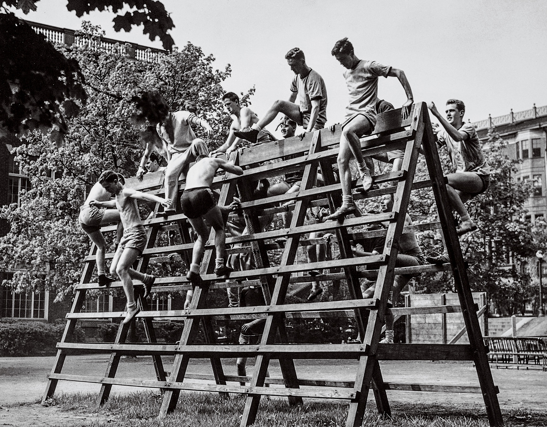 An image of students in the V-12 Navy College Training Program climbing over a structure on campus in the 1940s