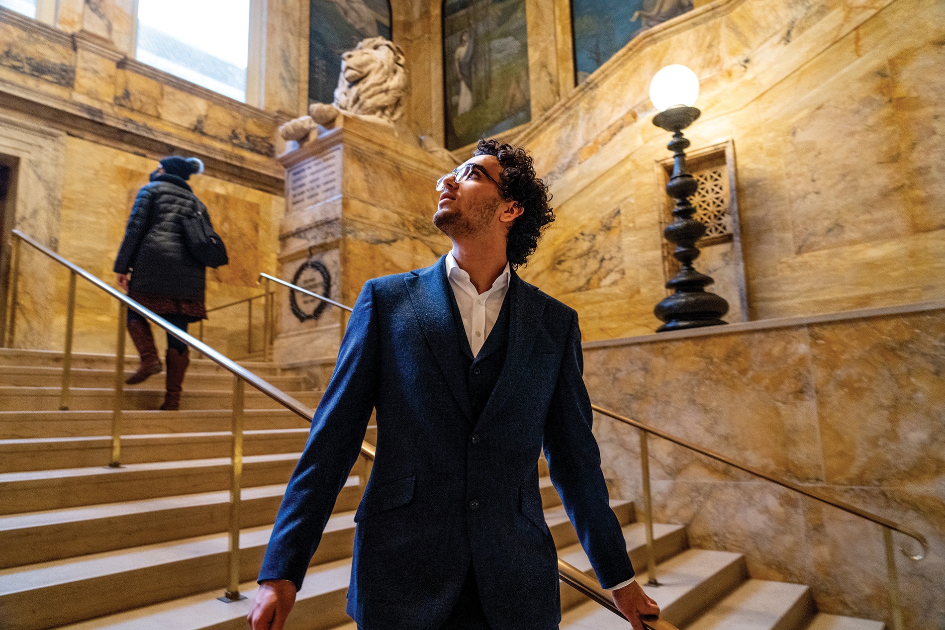 Image of Karim Zohdy looking up in the stairwell of the Boston Public Library