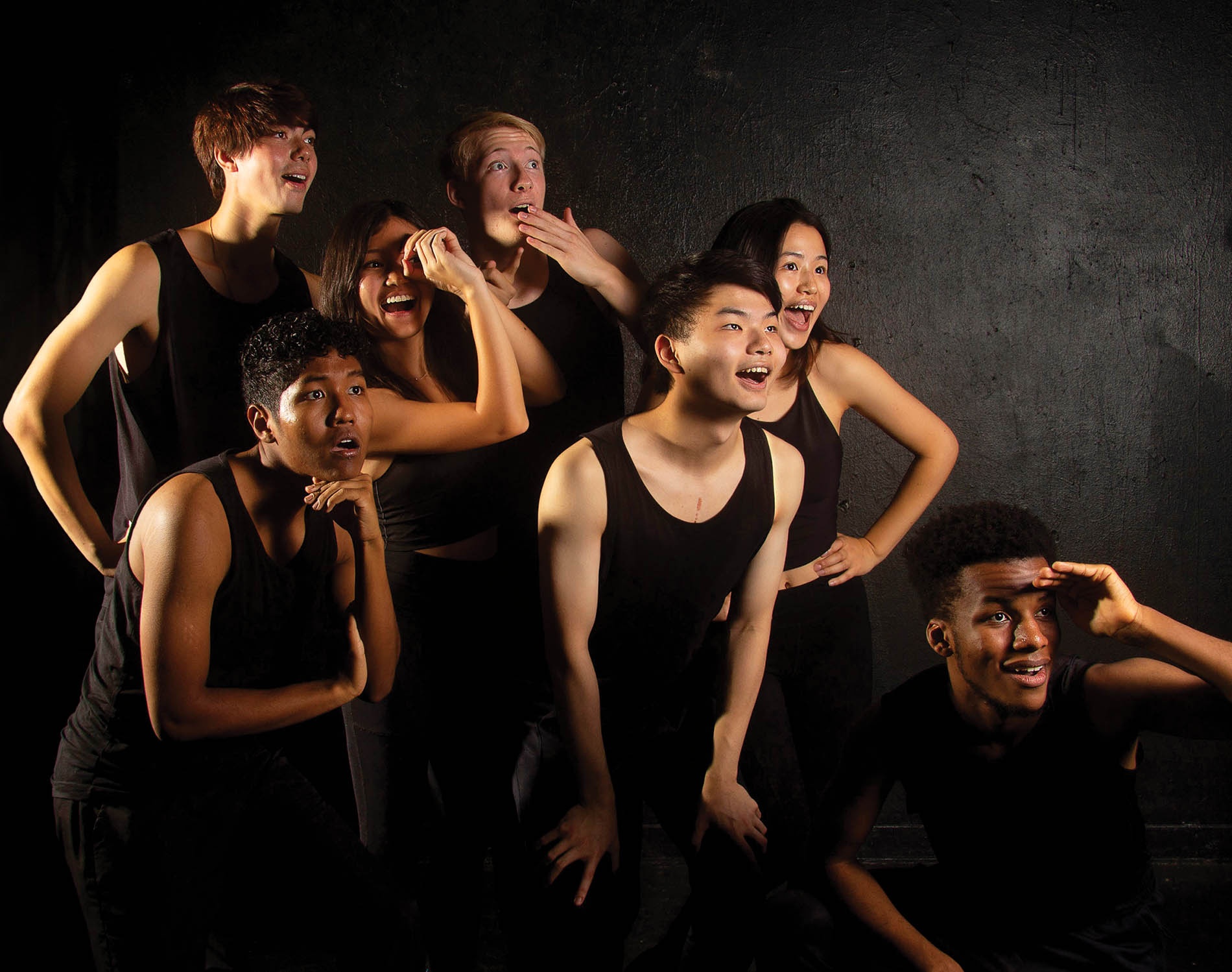 Image of Brown's Gendo Taiko club members dressed in black looking off camera to the right.