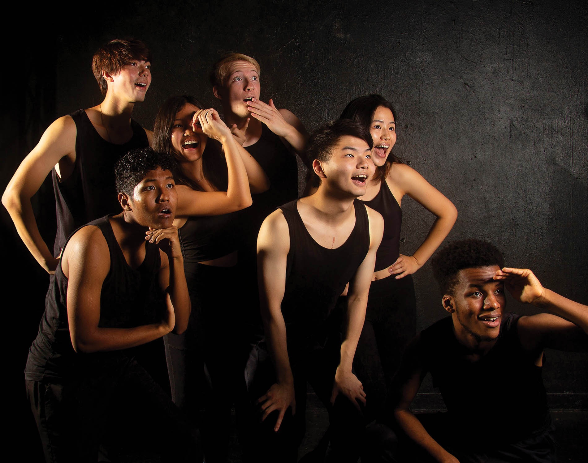 Image of Gendo Taiko drummers dressed in black all looking off to the side making silly expressions.