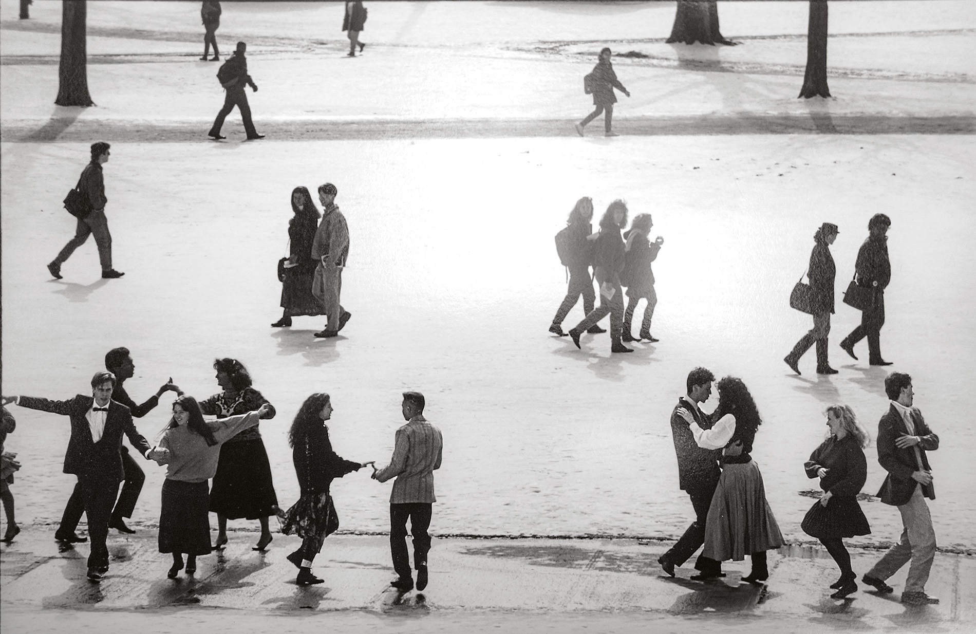 An archival image of students dancing on a snow-covered University green.