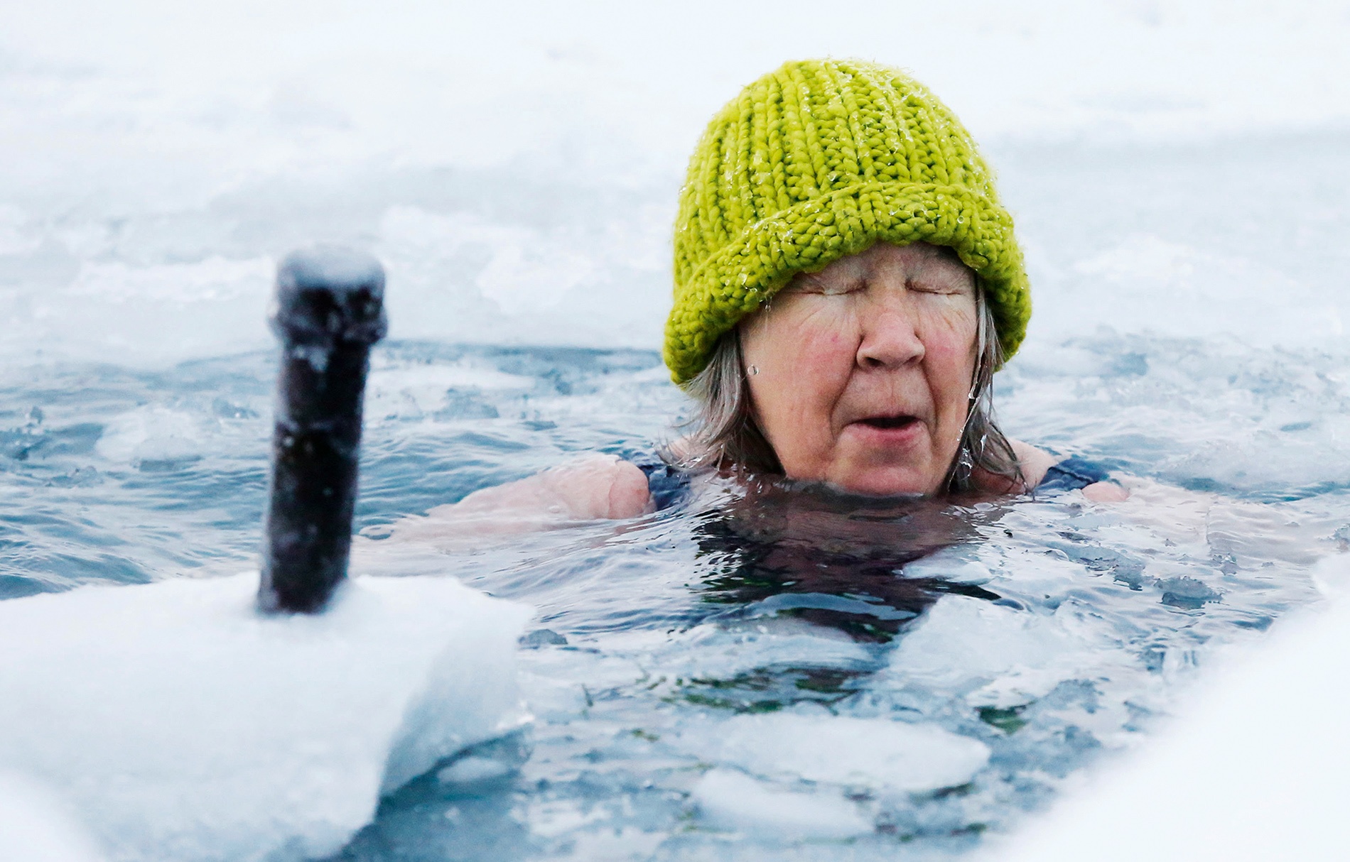 Image of Helen Wagner with eyes closed and a winter hat on in icy water.