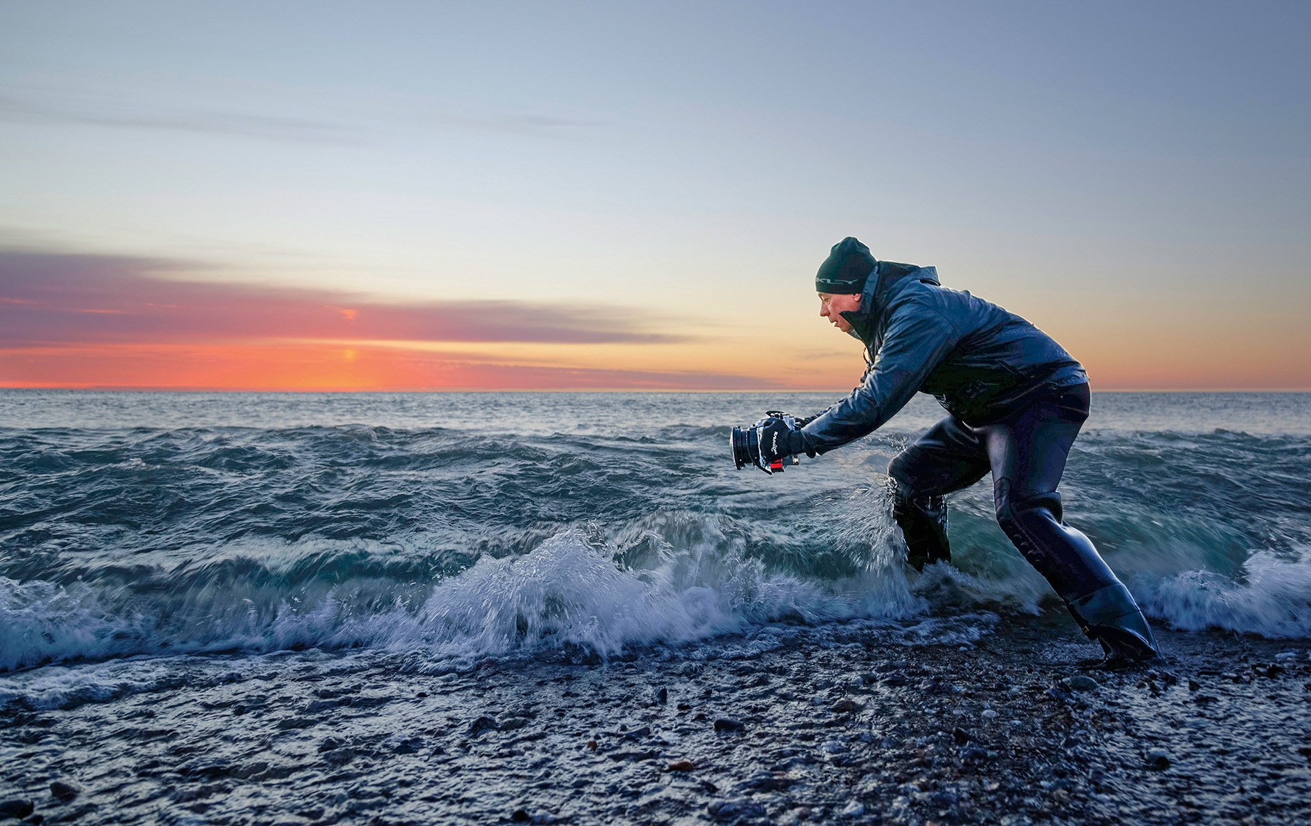 Image of Steven Koppel taking a photo in the surf.