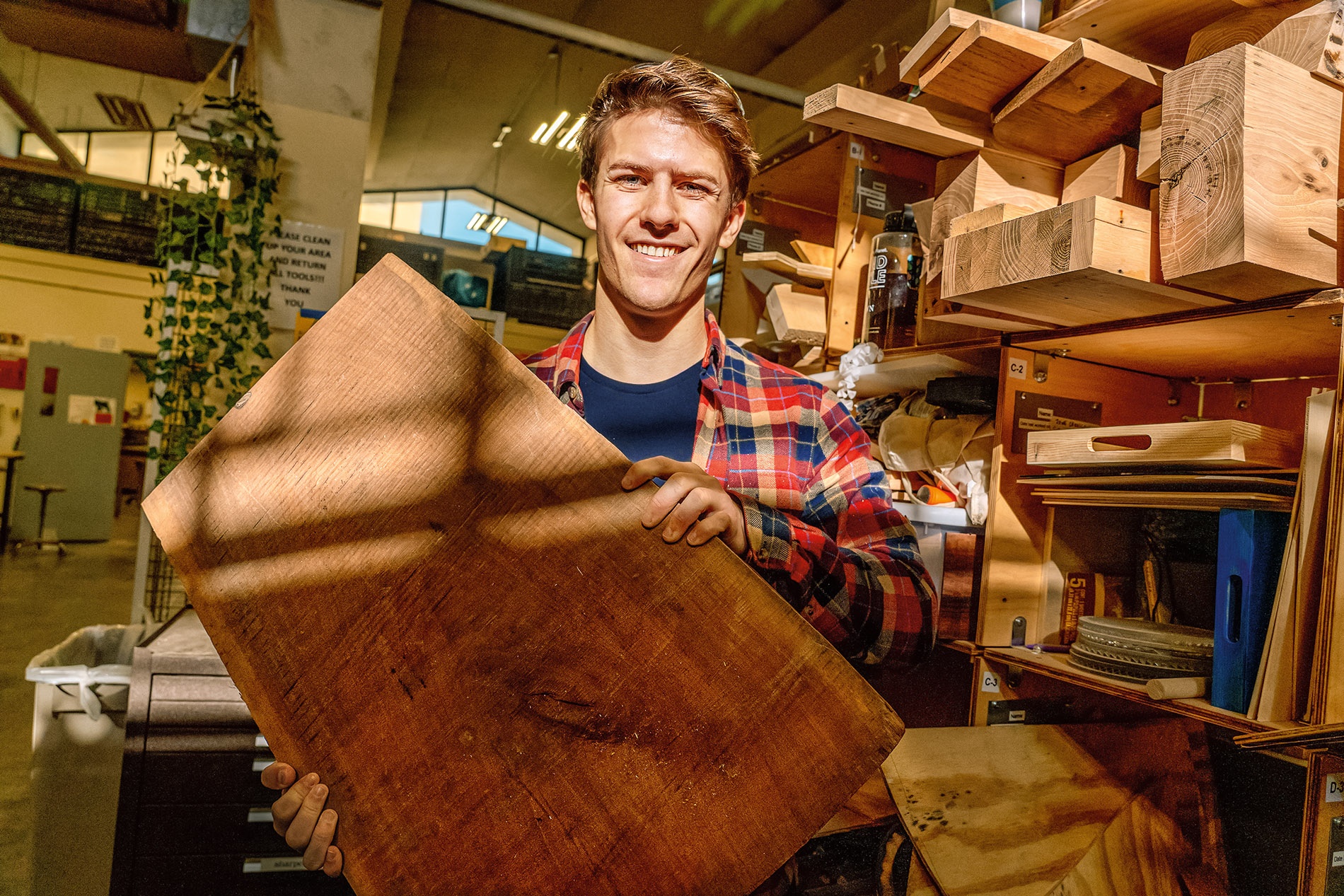 Image of Wyatt Woodbery holding a slab of black walnut.