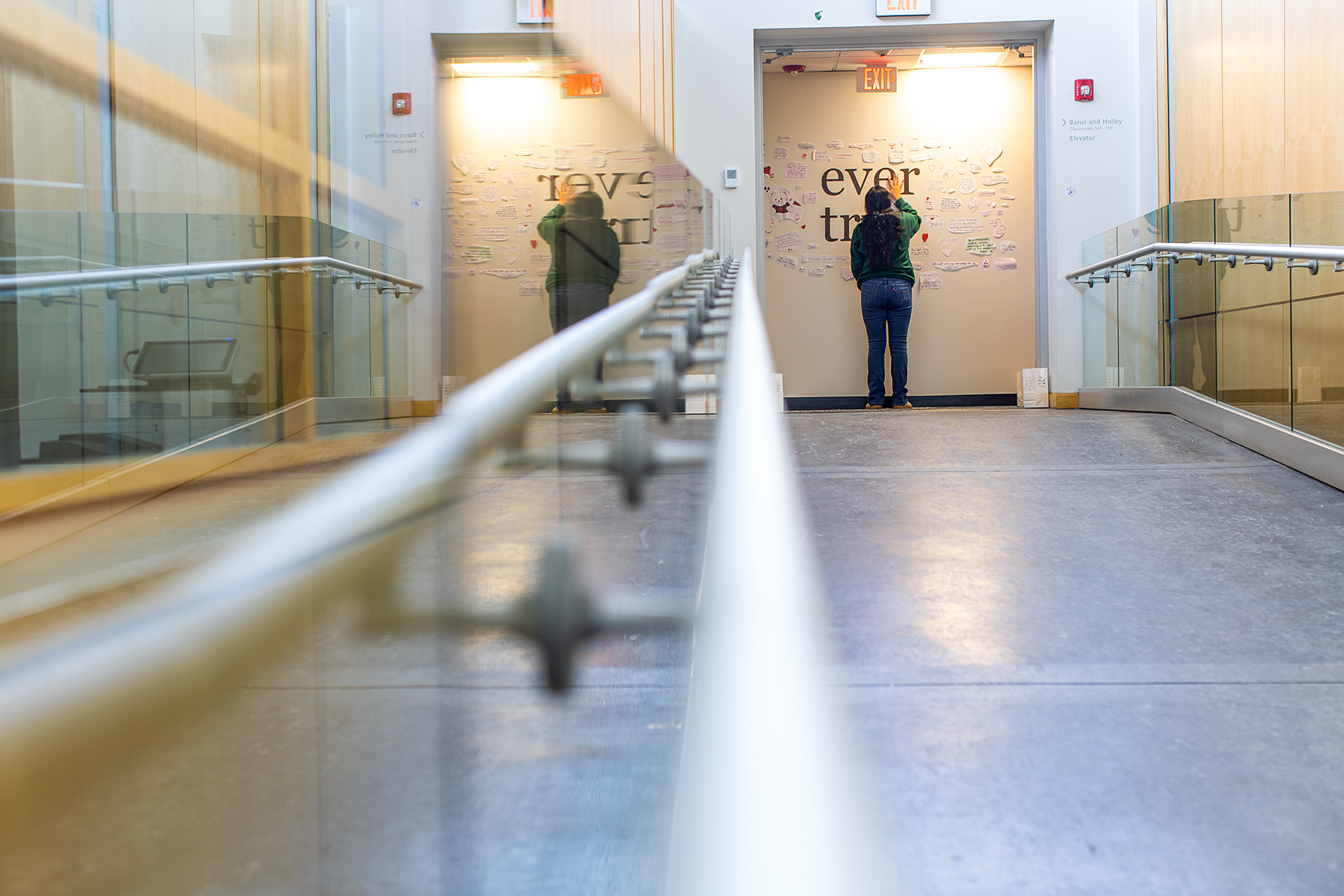 a student stands at a memorial wall