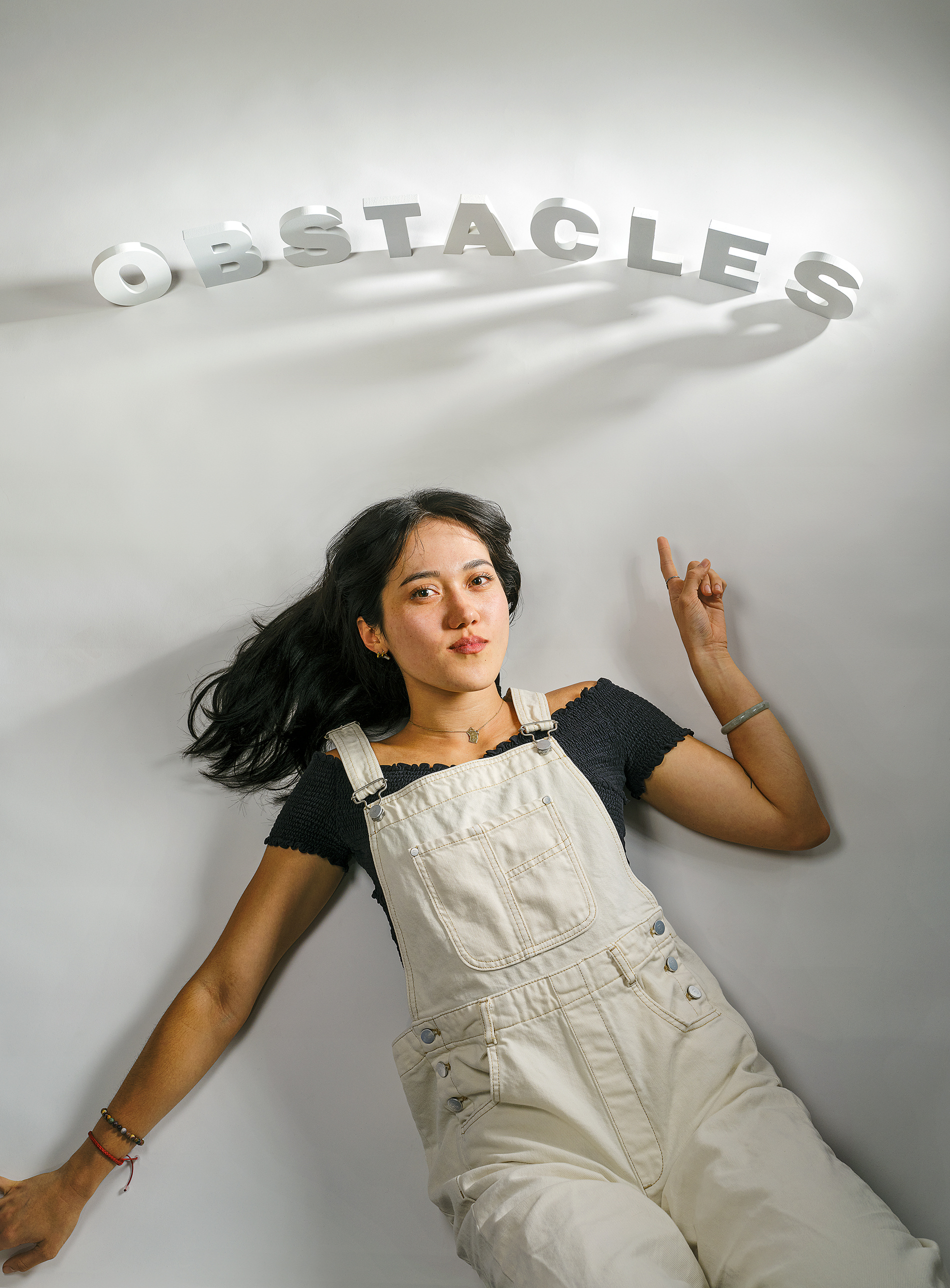 Heidi Erwin points to letters that spell out Obstacles