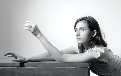Black and white photograph of Ottessa Moshfegh ’11 sitting at a table