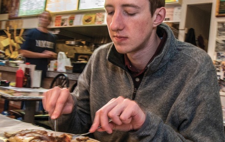 Student Peter Deegan eats pancakes at Louie's