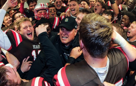 Estes and the Bears celebrate a win over URI at the 2015 Governor’s Cup.