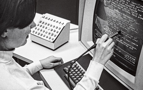 In a vintage photo, Christine Braun ’70 works with a light pen