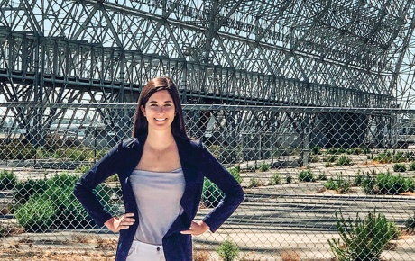 Ariel Deutsch standing outside an old NASA hangar