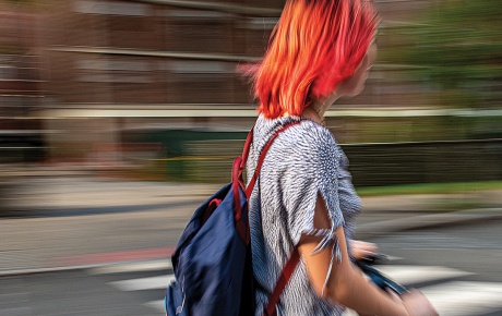 Motion-blurred photo of a student on a scooter