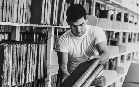 Image of student unpacking books at the Rockefeller Library at Brown