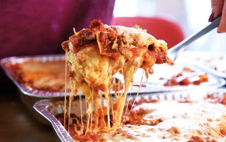 Image of lasagna coming out of the pan