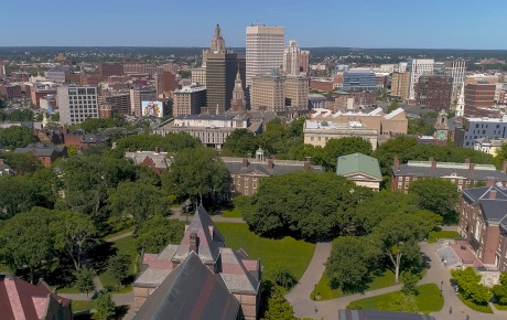 Overhead image of Brown campus in foreground and Providence in background. 