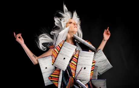 Image of a model surrounded by Kent Stetson's handbags in the shape of a moth.