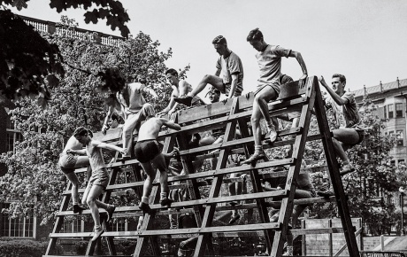 An image of students in the V-12 Navy College Training Program climbing over a structure on campus in the 1940s