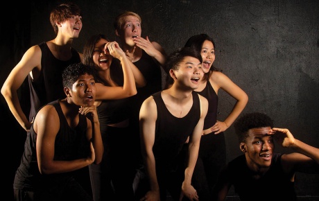 Image of Brown's Gendo Taiko club members dressed in black looking off camera to the right. 