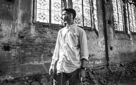 Black and white image of Jonah Blumenthal in a rundown building.