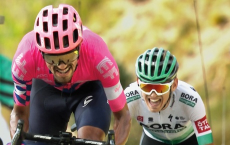 A close-up inage of two professional bicyclists racing.