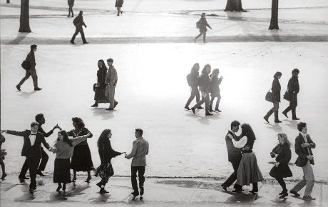 An archival image of students dancing on a snow-covered University green.