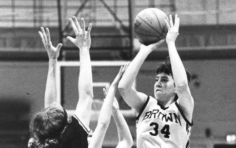 Black and white image of Christa Champion shooting the basketball in a Brown game in 1984.