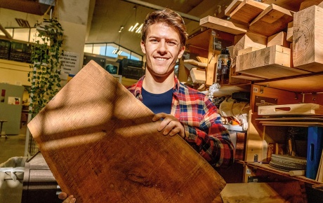 Image of Wyatt Woodbery holding a slab of black walnut.