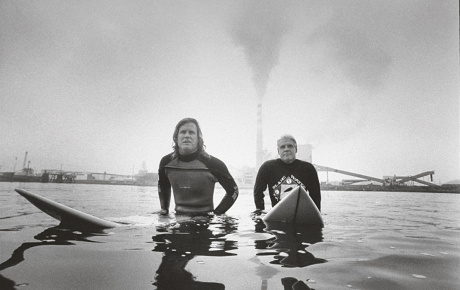 Surfers sitting on their boards